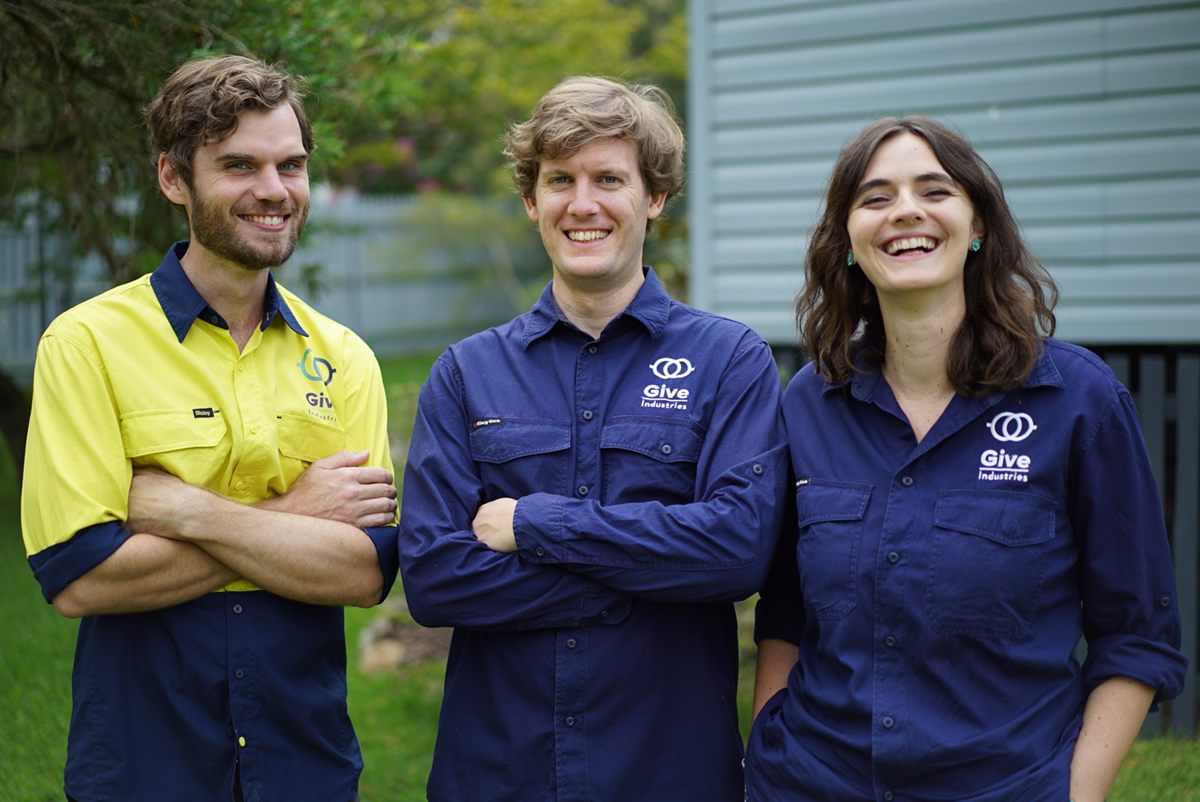 Give Industries team members smiling together