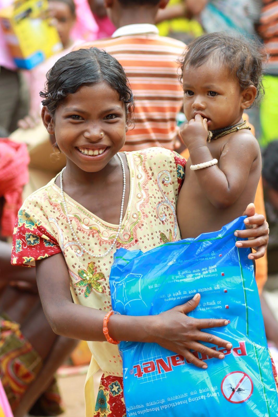 Child looking toward the camera during charity-supported community work in India